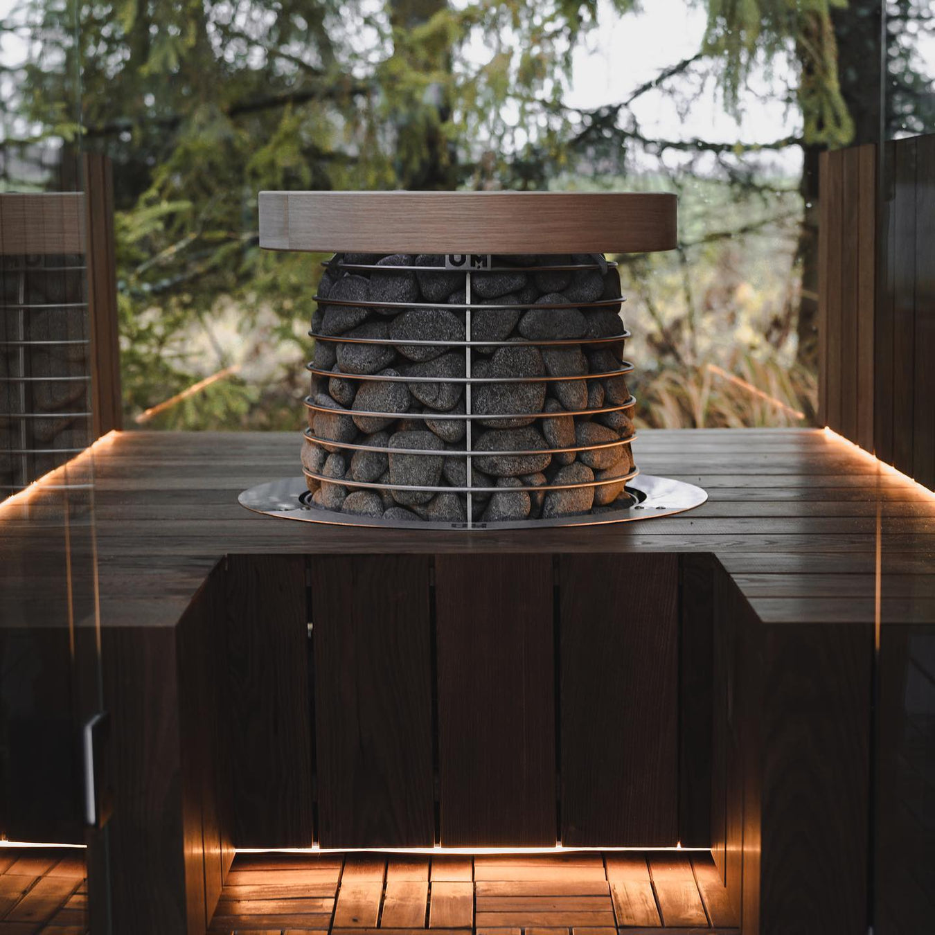 Custom Sauna With Dark Raised Floor and HUUM Hive Mini Centerpiece